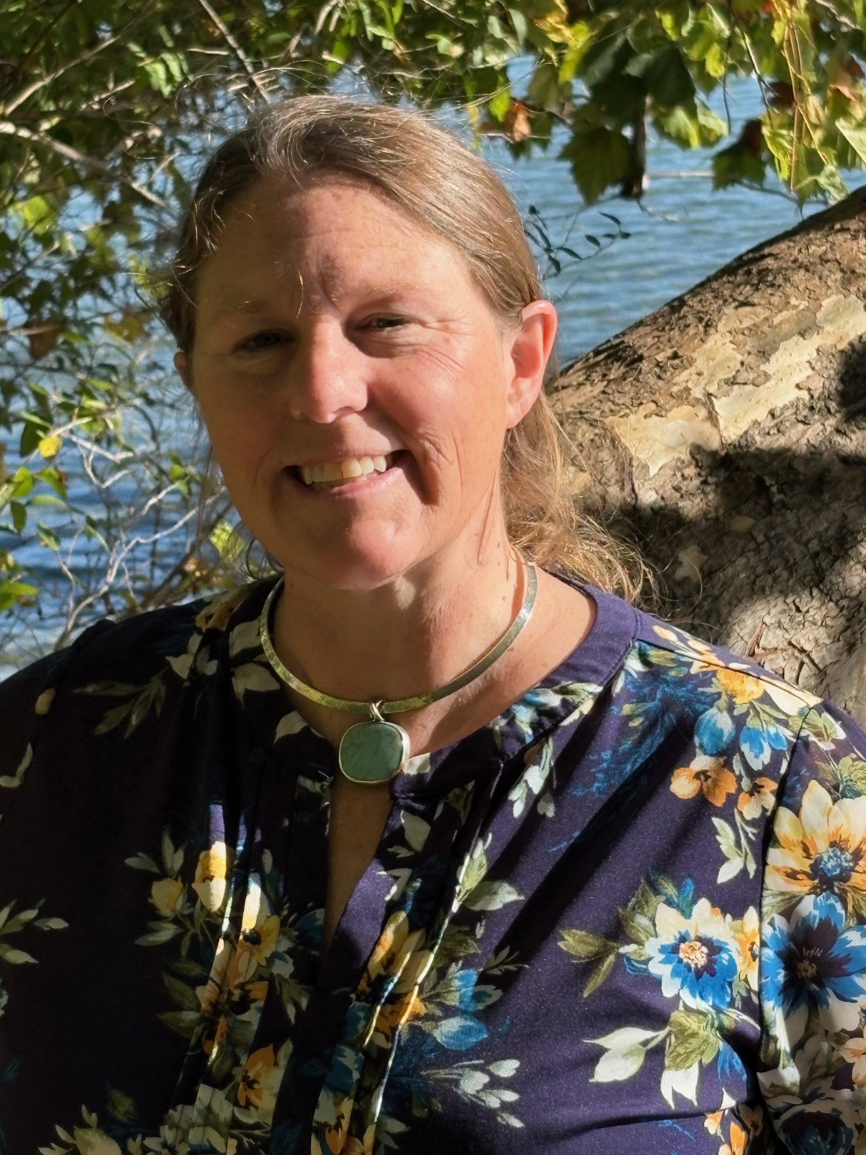 Close up of Helen Freeh with water and vegetation in background