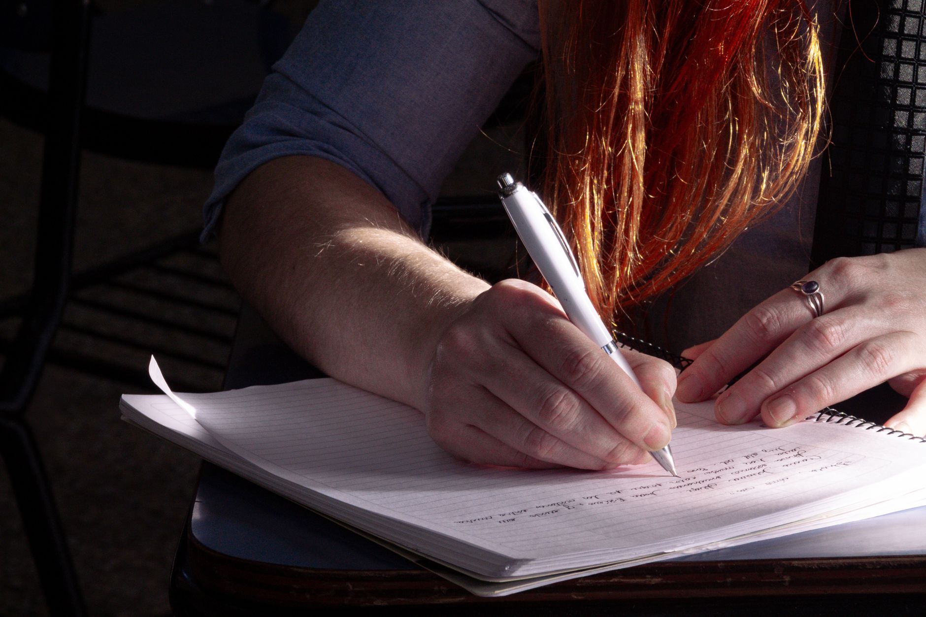 close up of writing hands in classroom setting